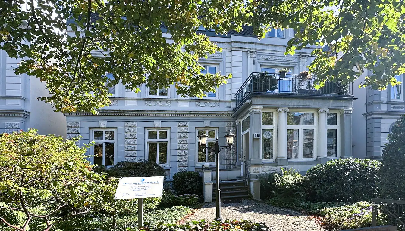 Weiß-graue Jugendstilvilla in Hamburg, in der sich die HNO-Praxis Bismarckstraße befindet, mit historischen architektonischen Details und großen Fenstern.